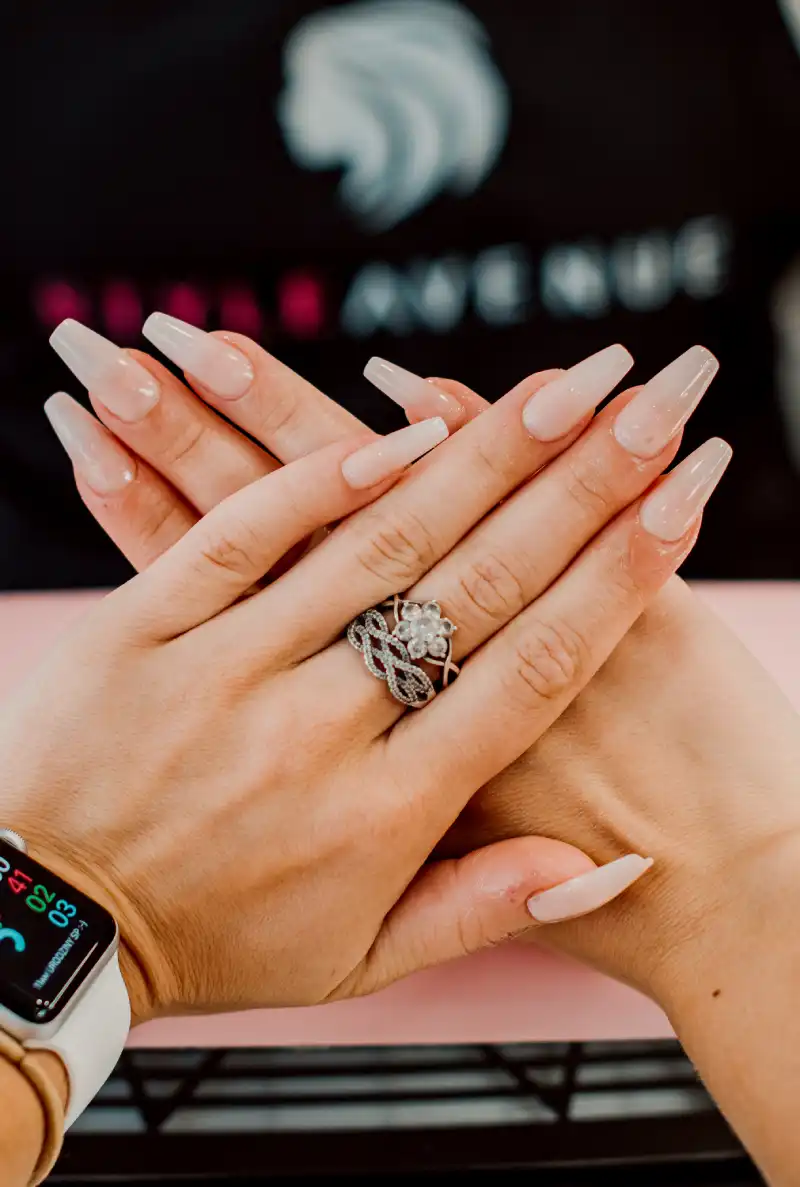 a client in a salon in Staines examining her nails after a manicure