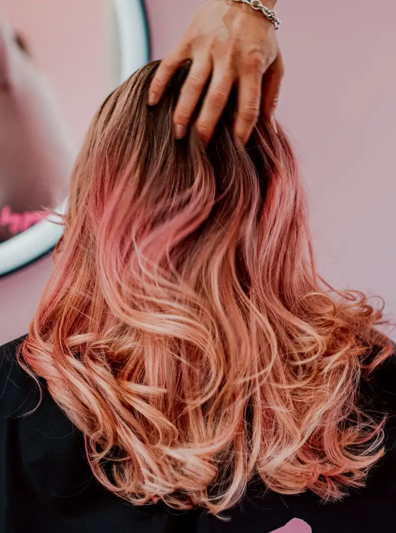 hairdresser styling a client's hair in hair salon in Staines