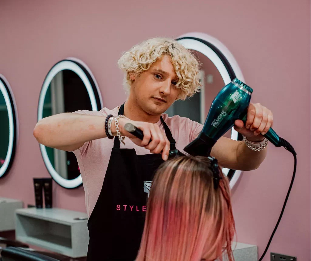 hairdresser drying a client's hair