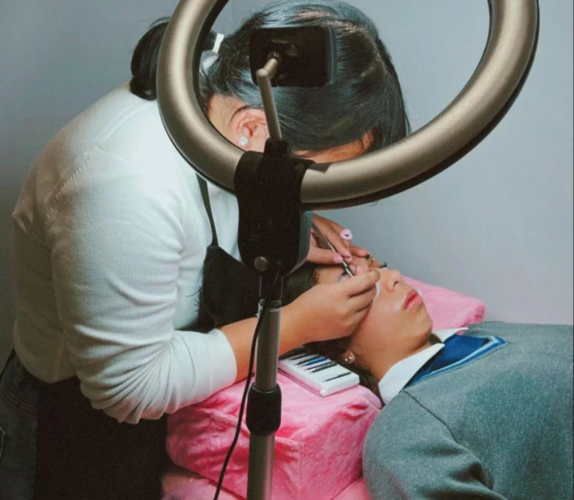 beautician doing a client's eyelashes in a salon in Staines
